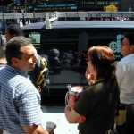 050 - 12.25PM - people gather around a radio for news