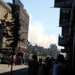 085 - Thu 1PM - downtown still smoking in background, ambulances lined up in front of piers