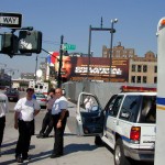 103 - Thu 1PM - ambulance drivers waiting for orders in front of a collatoral damage billboard